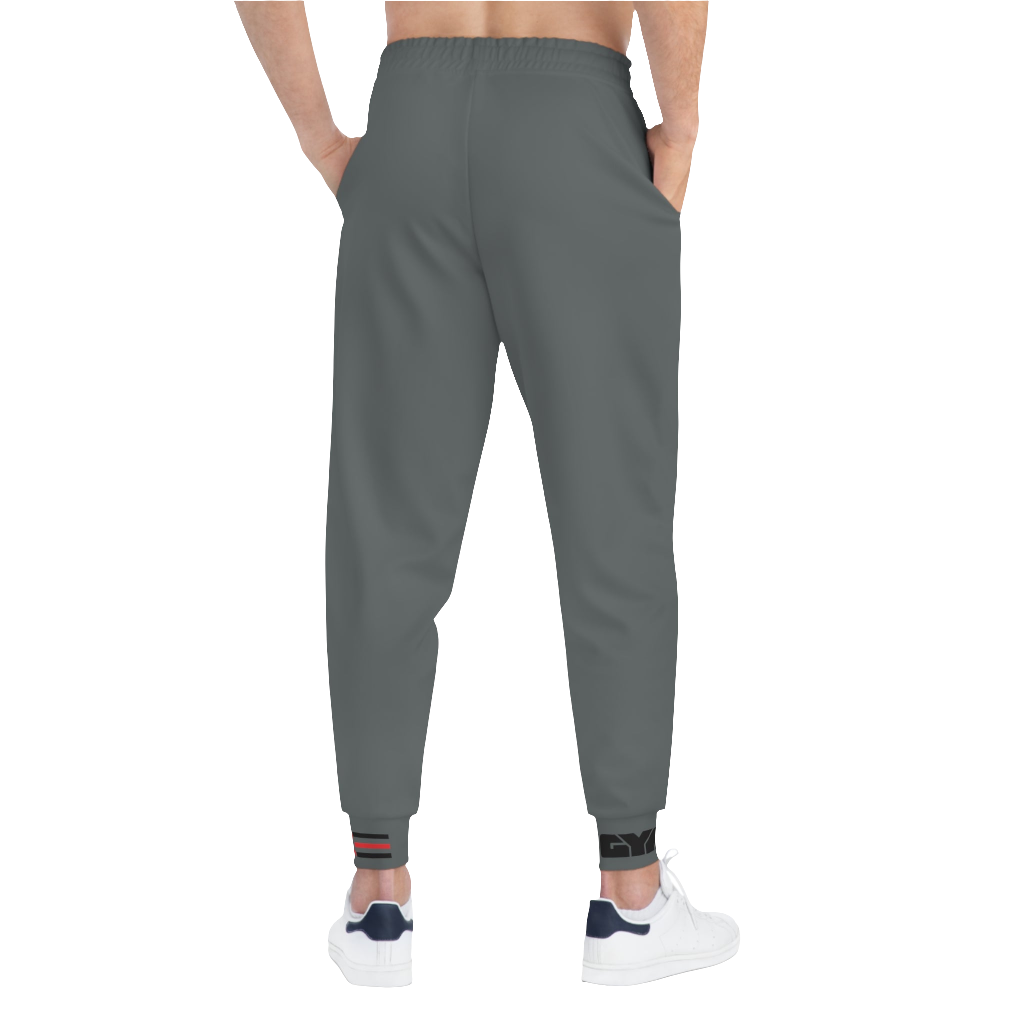 A person standing back side, wearing silver gray joggers Gymstar with a logoand white sneakers. The joggers have a ribbed bottom and waistband cuffs, and feature two side pockets.