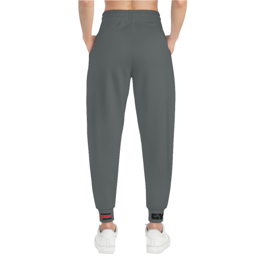 A person standing frontal, wearing silver gray joggers Gymstar with a logoand white sneakers. The joggers have a ribbed bottom and waistband cuffs, and feature two side pockets.