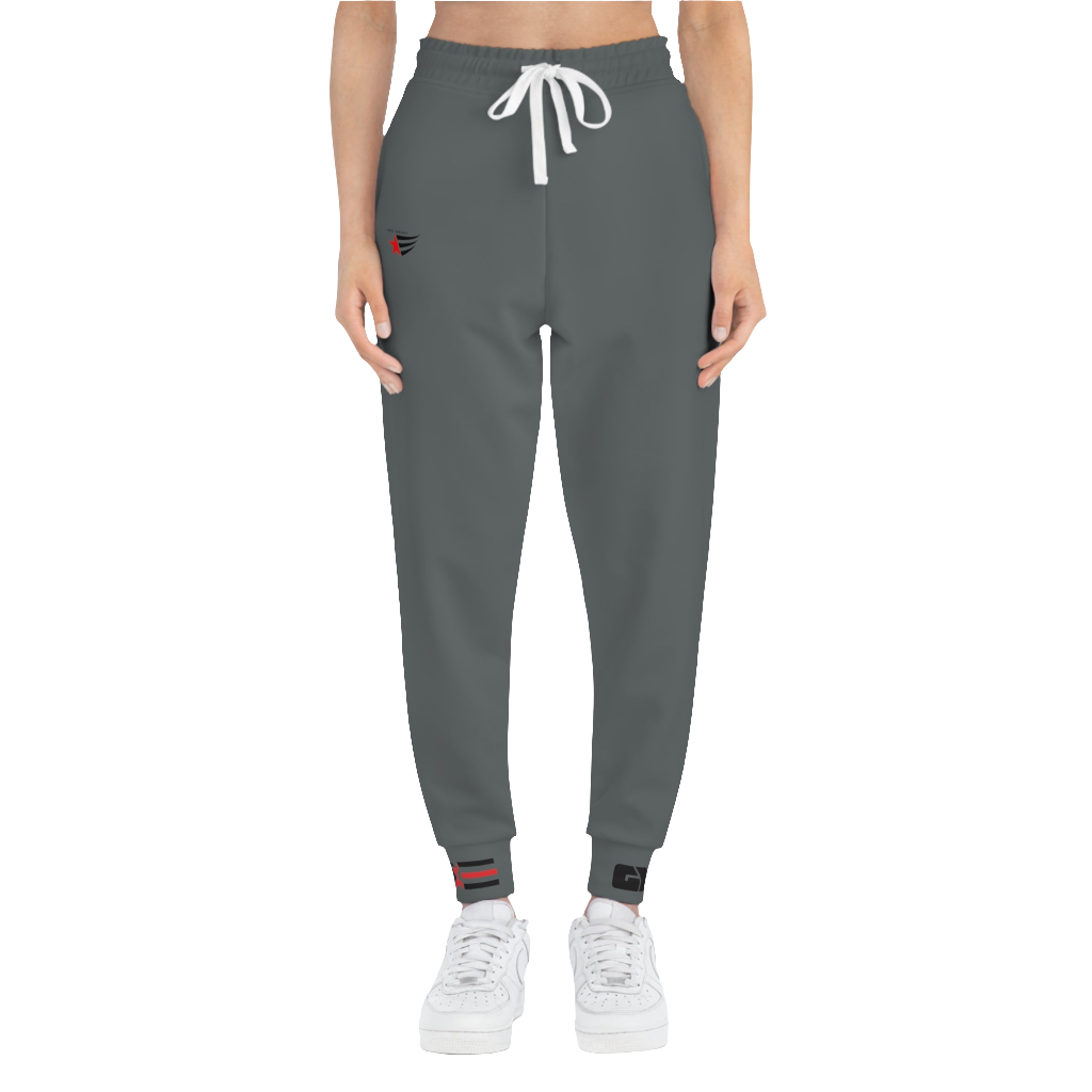 A person standing frontal, wearing silver gray joggers Gymstar with a logoand white sneakers. The joggers have a ribbed bottom and waistband cuffs, and feature two side pockets.