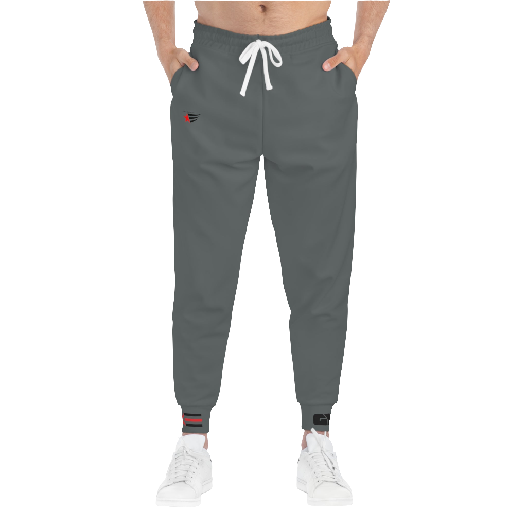 A person standing frontal, wearing silver gray joggers Gymstar with a logoand white sneakers. The joggers have a ribbed bottom and waistband cuffs, and feature two side pockets.