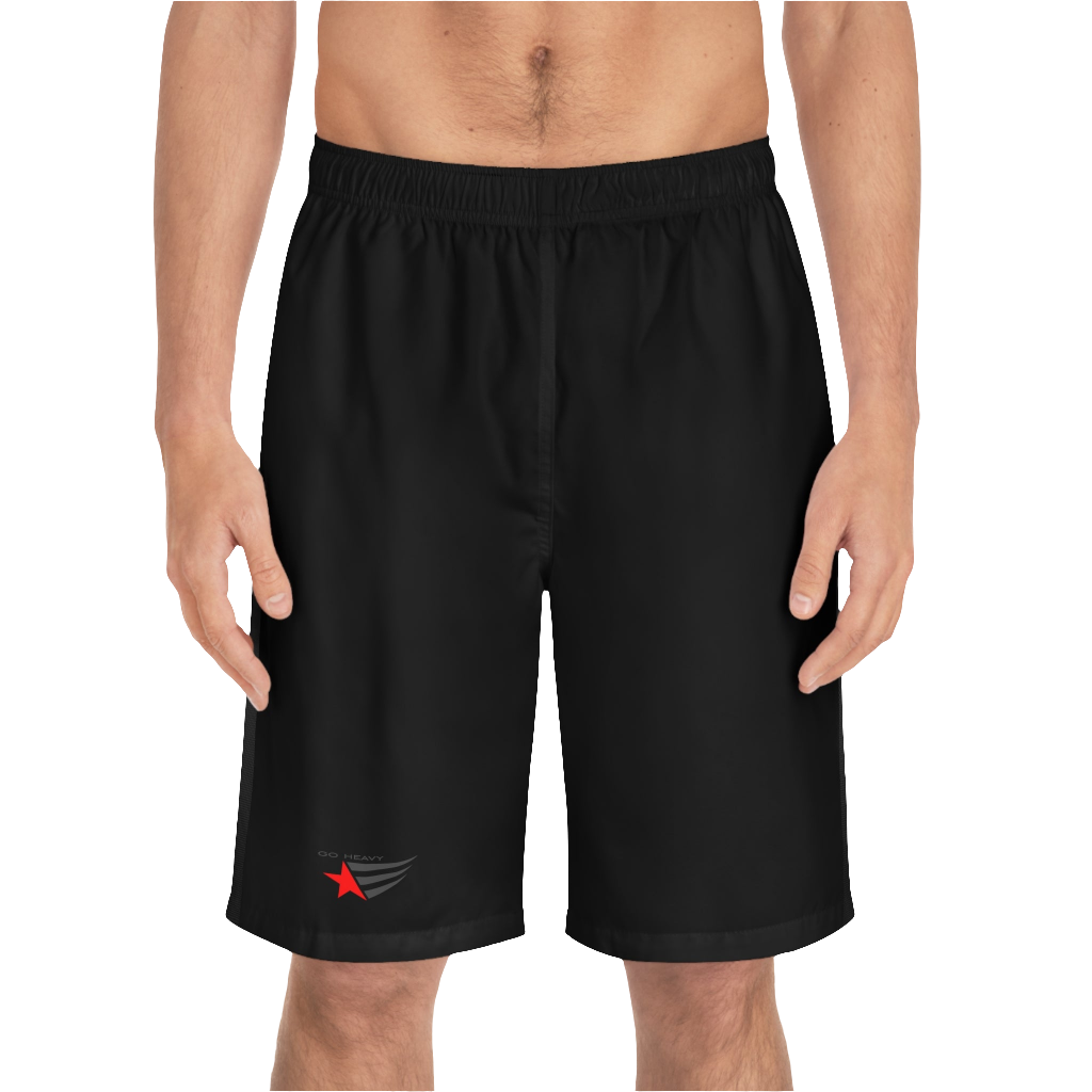 A man wearing black sports shorts with an elastic waistband and drawstrings, featuring a logo on the left leg  front side view.
