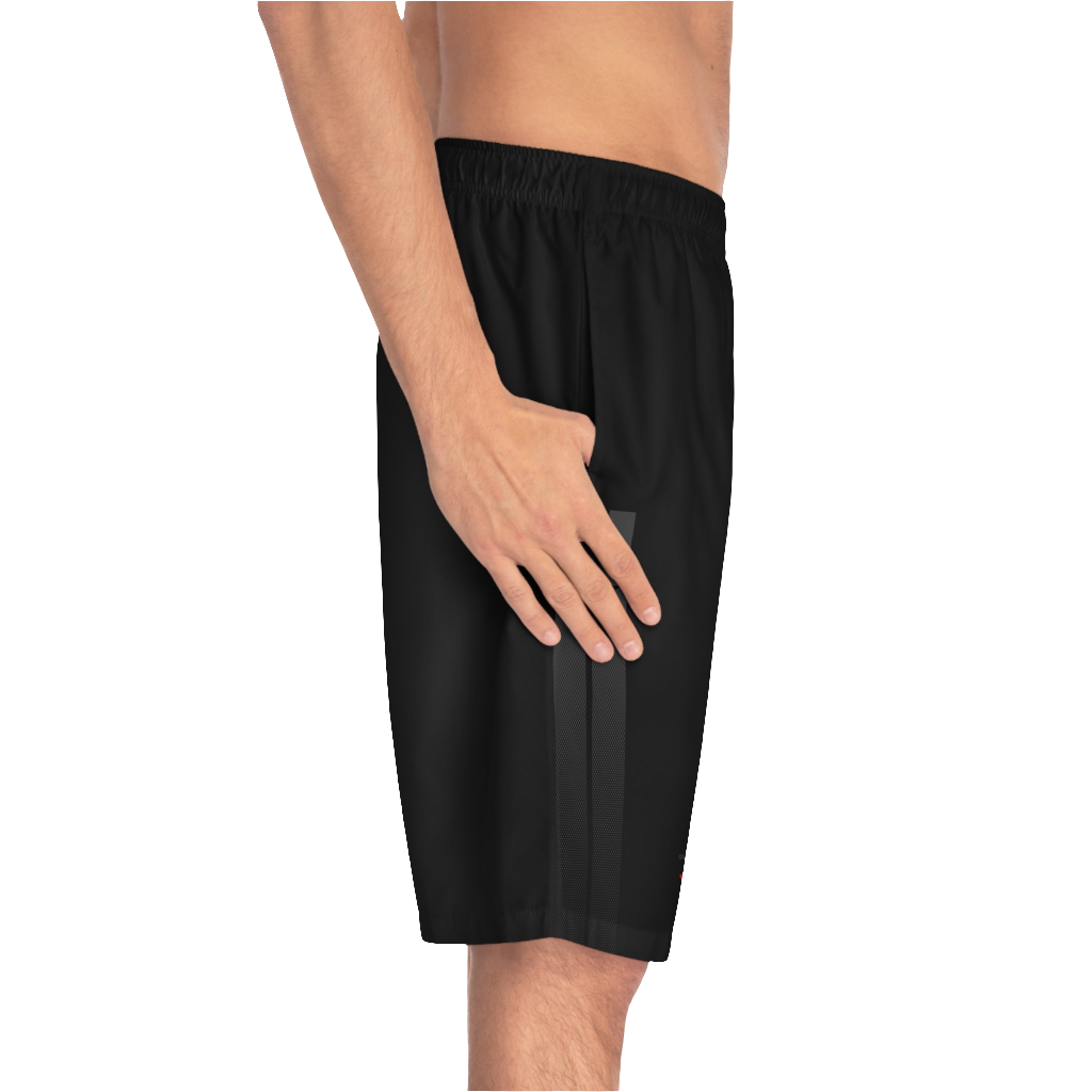 A man wearing black sports shorts with an elastic waistband and drawstrings, featuring a logo on the left leg  left side view.