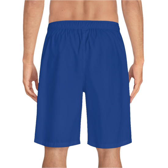 A man wearing pair of dark blue men's board shorts with a small Gymstar logo on the left leg back side view.