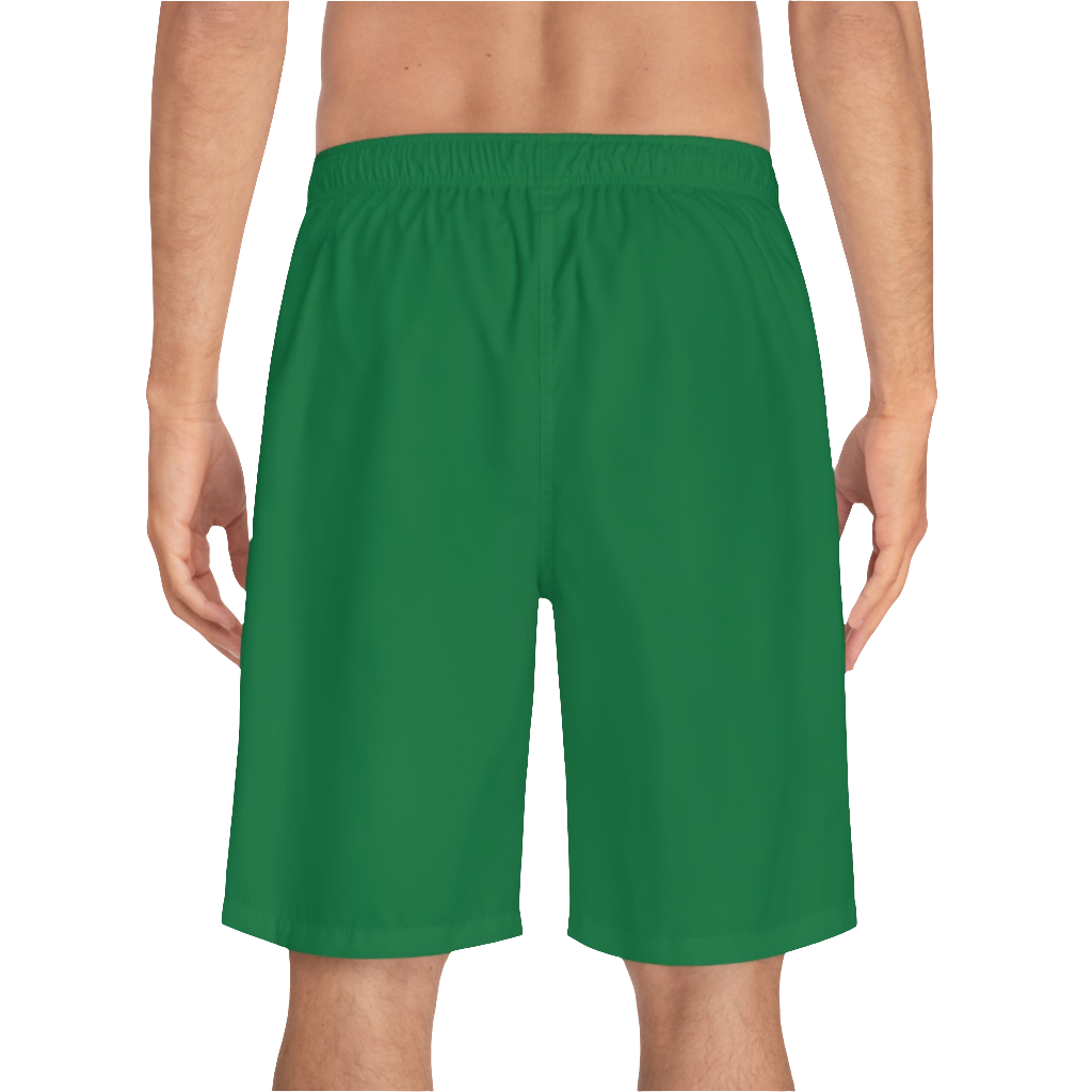 A man wearing pair of green men's board shorts with a small Gymstar logo on the left leg back side view.