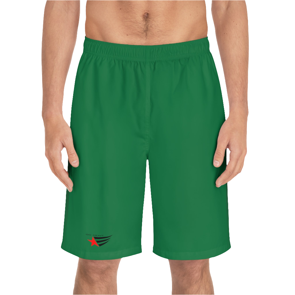 A man wearing pair of green men's board shorts with a small Gymstar logo on the left leg front side view.