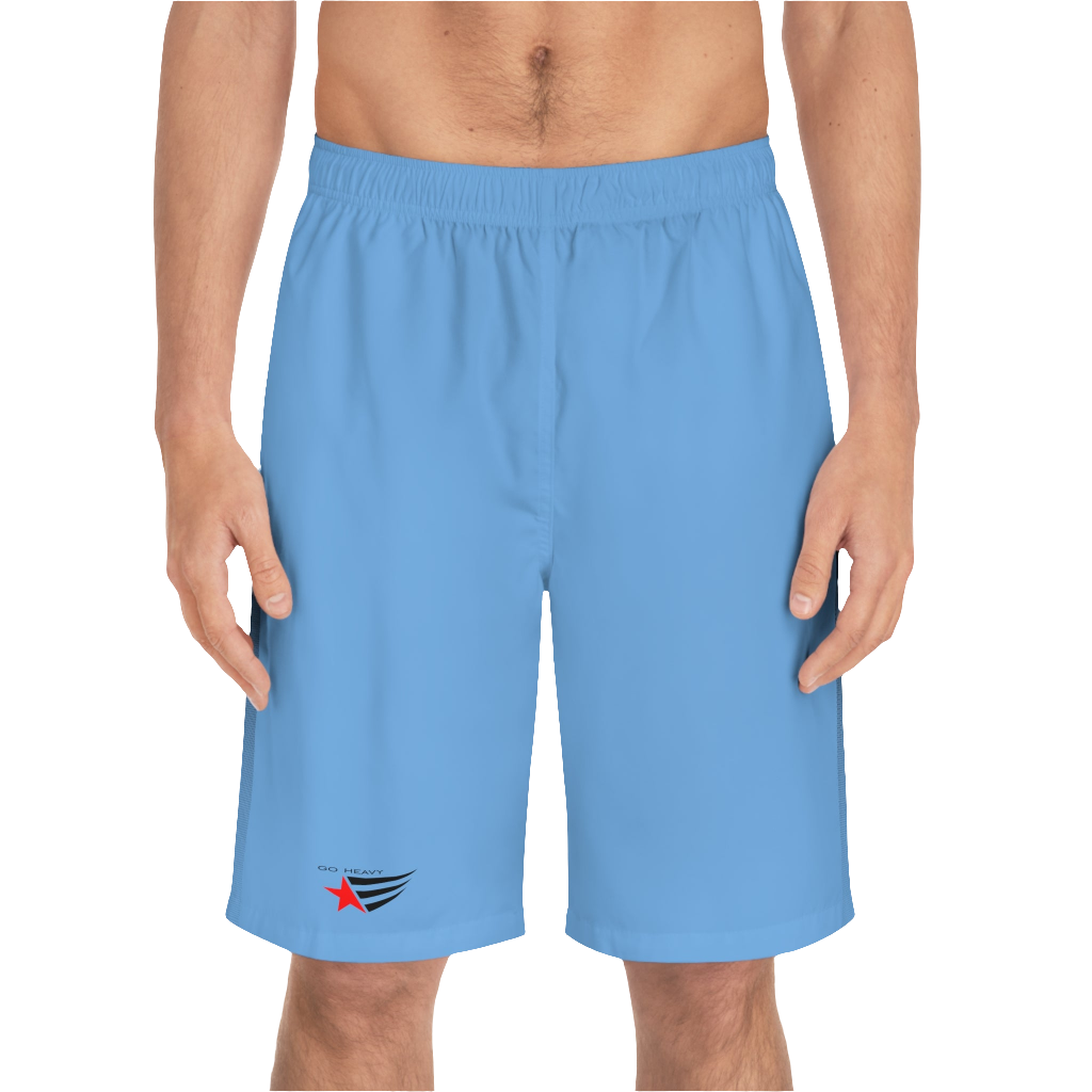 A man wearing pair of blue men's board shorts with a small Gymstar logo on the left leg front side view.