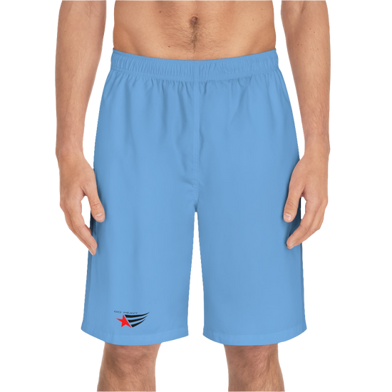 A man wearing pair of blue men's board shorts with a small Gymstar logo on the left leg front side view.