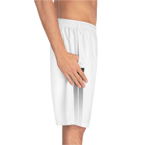 A man wearing pair of white men's board shorts with a small Gymstar logo on the left leg left side view.