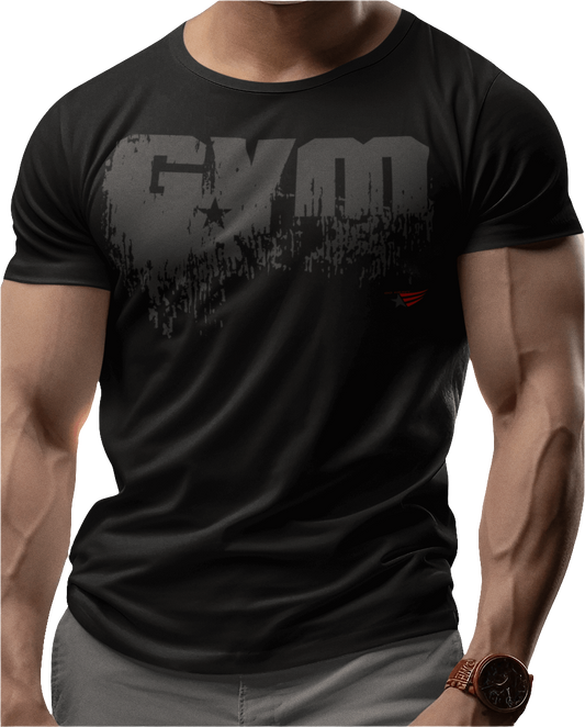 A man wearing black sports t-shirt from Gymstar with a minimalist yet powerful design. The chest features a large, distressed print of the word "GYM" in grey. The design is complemented by a small brand logo with a red star, which adds a stylish accent. The t-shirt is perfect for athletic wear, creating a modern and clean look.