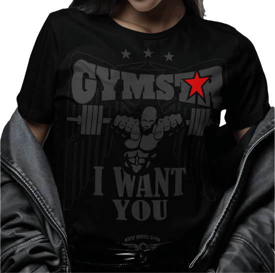 A woman wearing black Gymstar t-shirt with the text 'I WANT YOU' printed on the front, along with graphics of a weightlifter and dumbbells. 