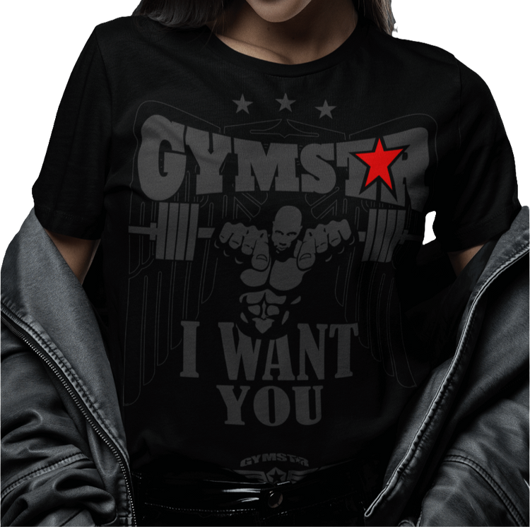 A woman wearing black Gymstar t-shirt with the text 'I WANT YOU' printed on the front, along with graphics of a weightlifter and dumbbells. 
